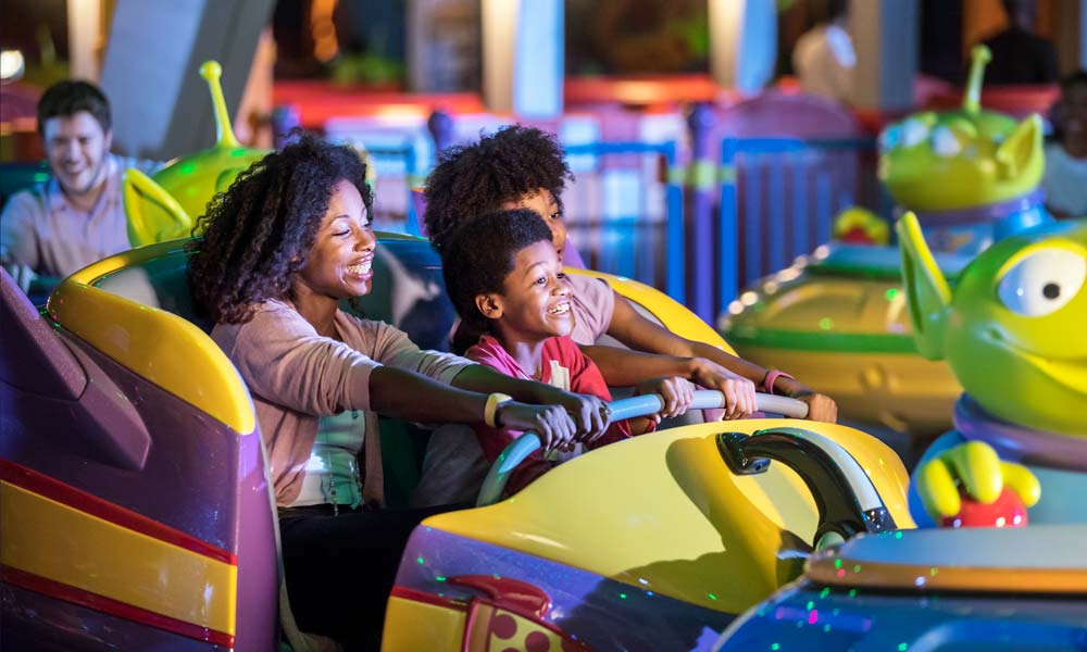 Family Riding Toy Story Land Swirling Saucers Ride At Walt Disney World ©Disney/Pixar